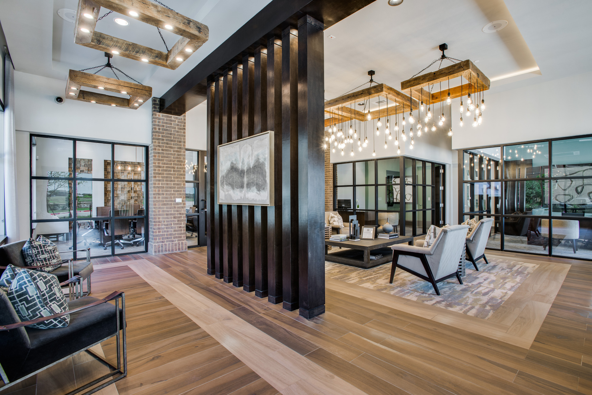Large decorated community lobby with designer lighting and comfortable seating