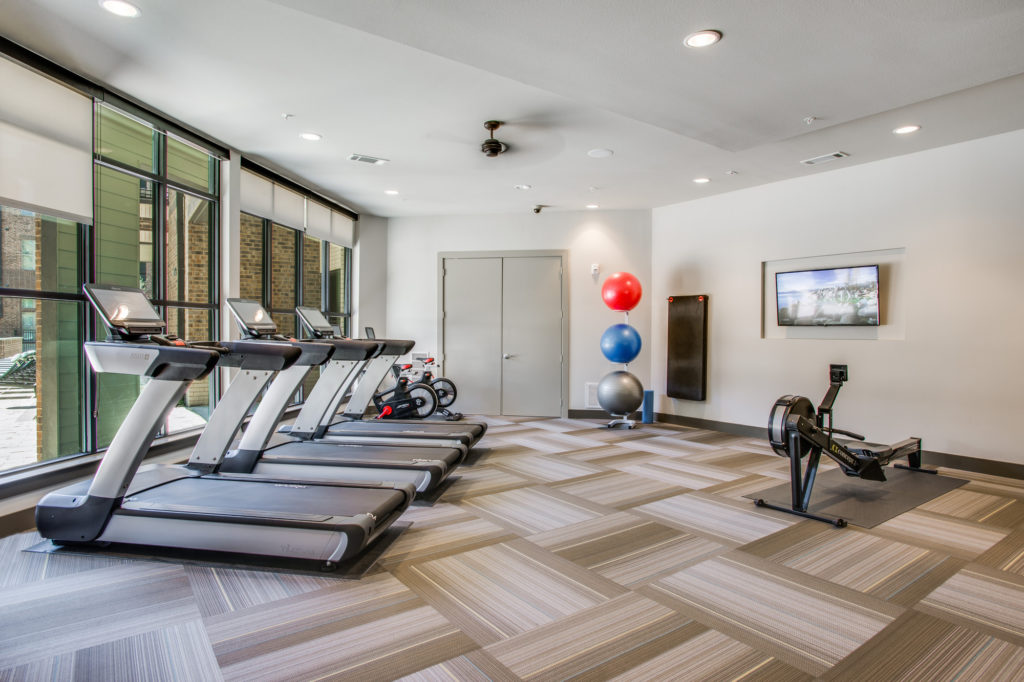 Fitness center with treadmills, cardio equipment, and strength training equipment