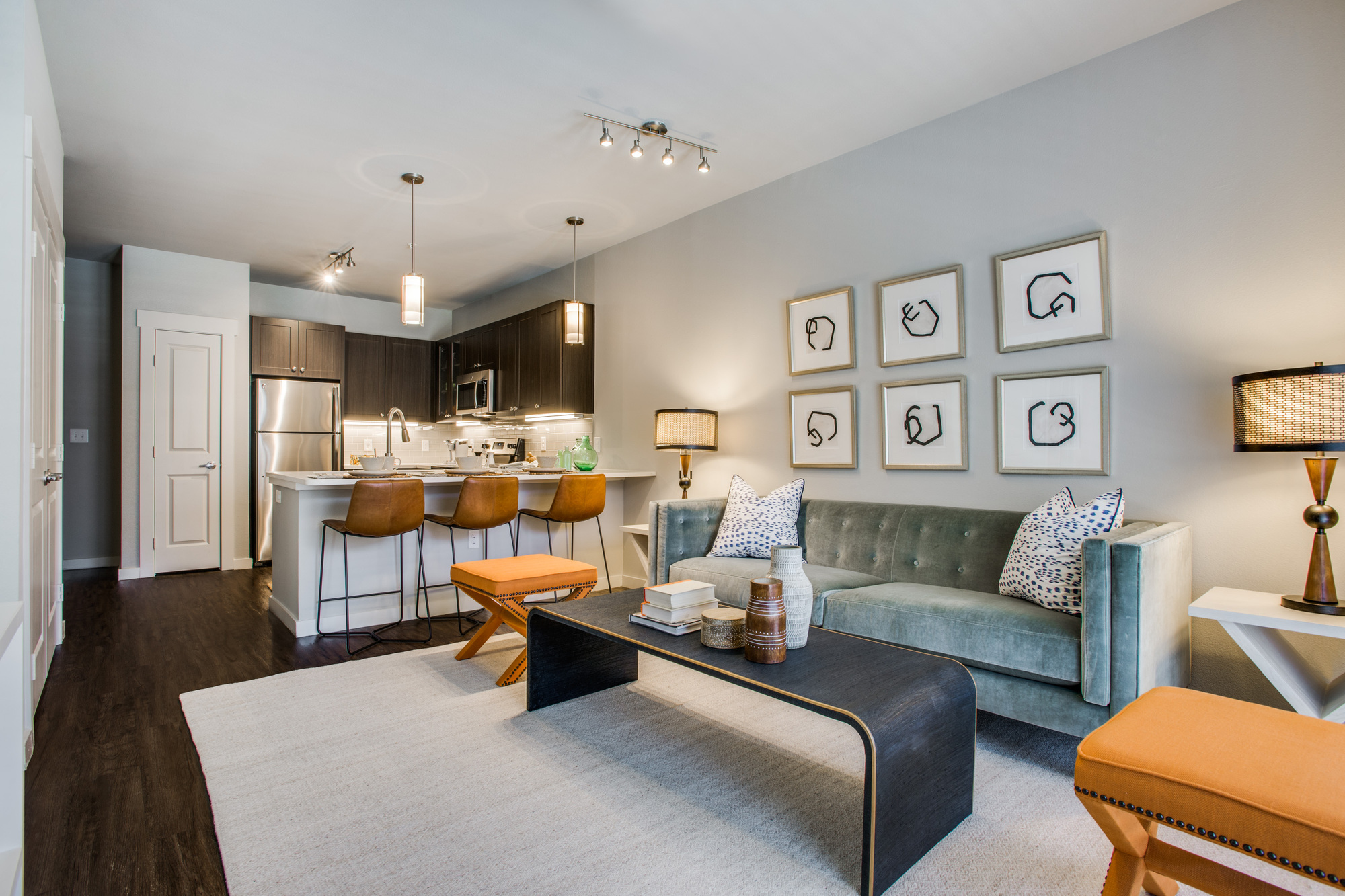 Model apartment interior view from living room to kitchen with hardwood flooring