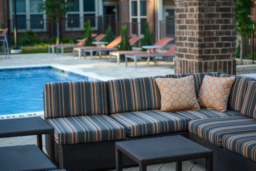 Large sectional couch seating near resort-style pool