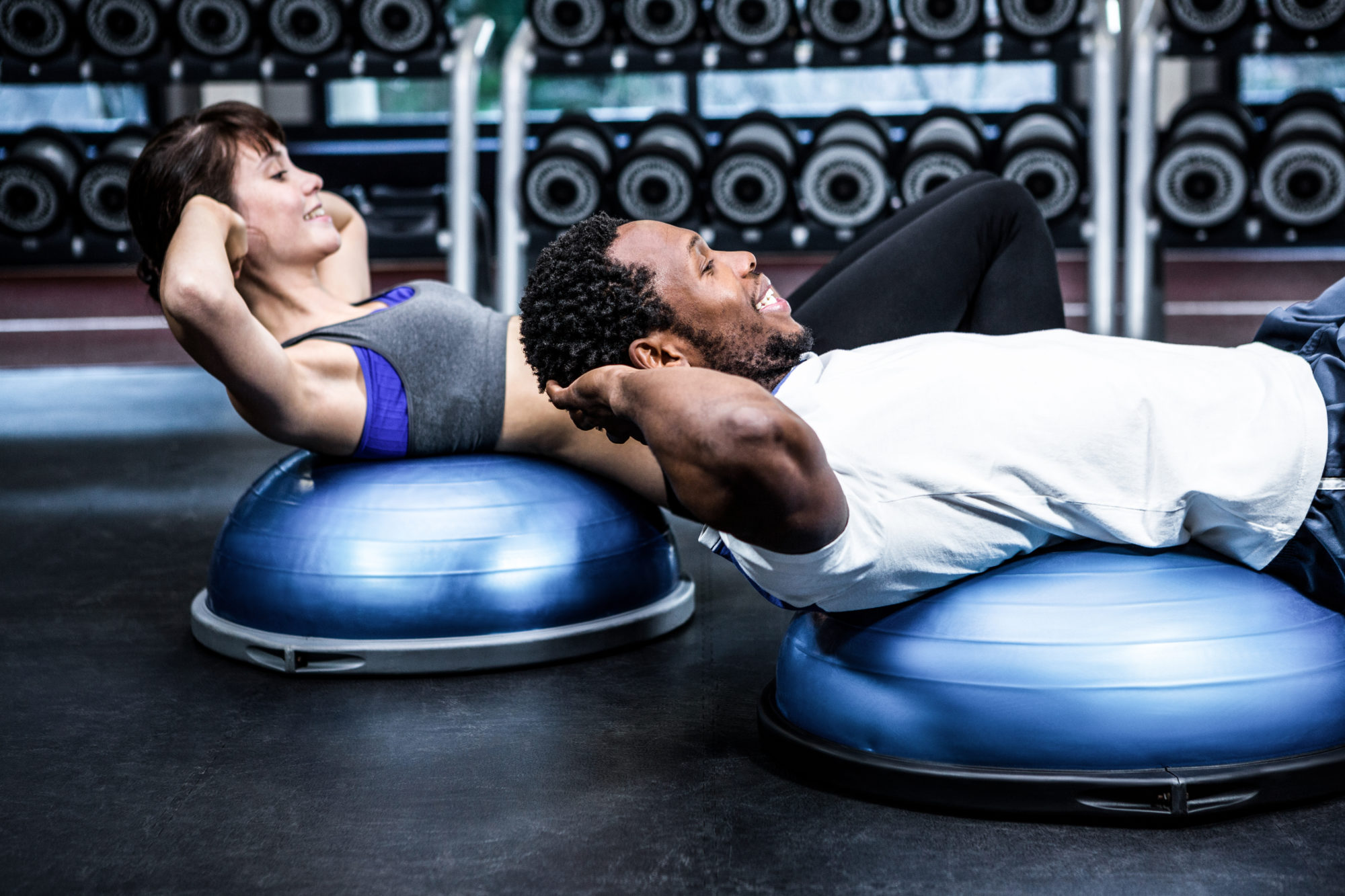 Two people exercising in apartment fitness center